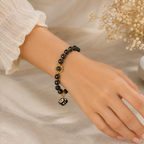 Black Beaded Bracelet with Gold Charms